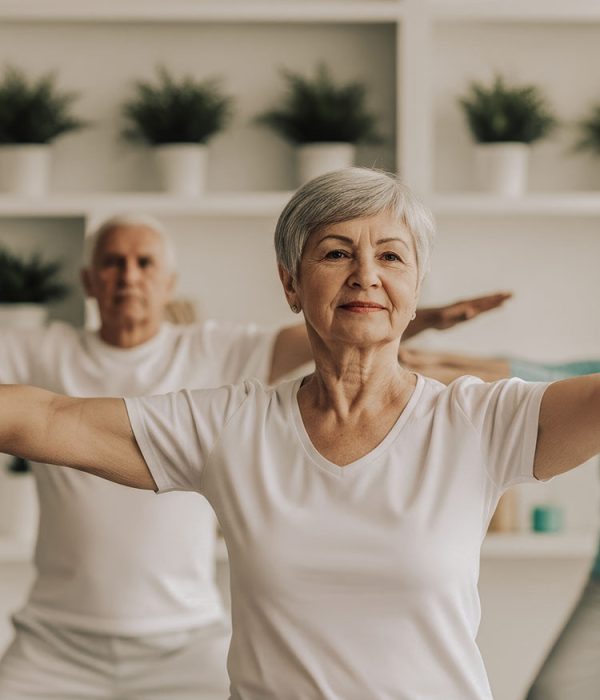 A diverse audience actively participating in a presentation by raising their hands, signifying engagement, interest, and a desire to contribute to the discussion.